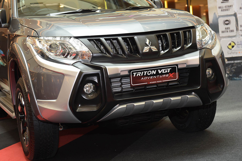 A dark chrome grille now adorns the bold front end of the Triton